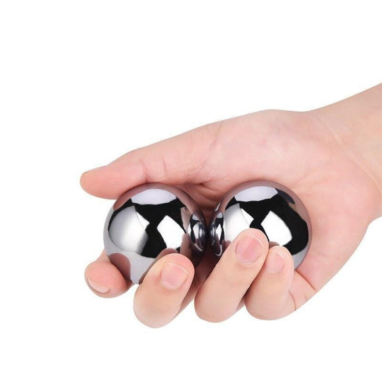 yin yang balls in hand